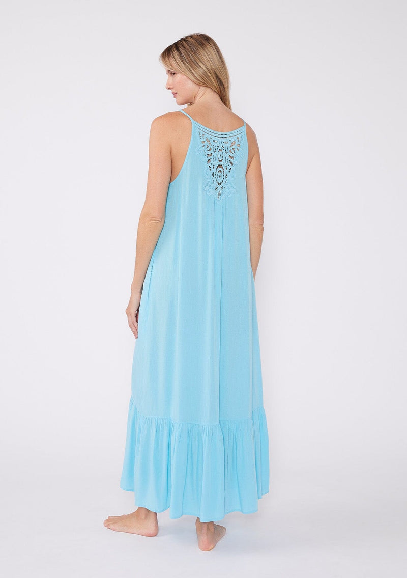 [Color: Aqua] A back facing image of a blonde model wearing an aqua blue bohemian sleeveless maxi dress. With spaghetti straps, a scoop neckline, side pockets, a long flowy tiered skirt, and a sheer lace racerback detail.