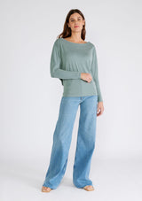 [Color: Slate Green] A full body front facing image of a brunette model wearing a seafoam green soft ribbed knit pullover. With long dolman sleeves and a wide boat neck that can be worn on or off the shoulder. 