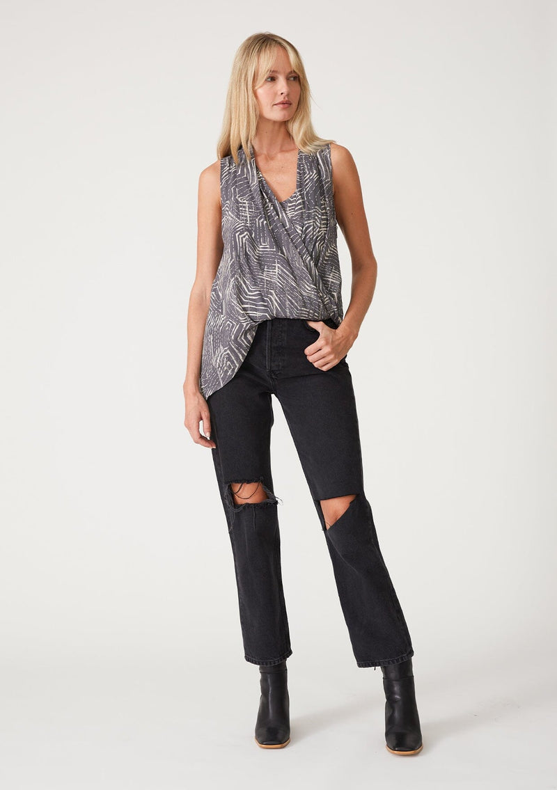 [Color: Grey/Cream] A full body front facing image of a blonde model wearing a grey printed tank top. With an asymmetric hemline, an exposed side zip closure, a surplice front, and an attached lining with a scoop neckline. 