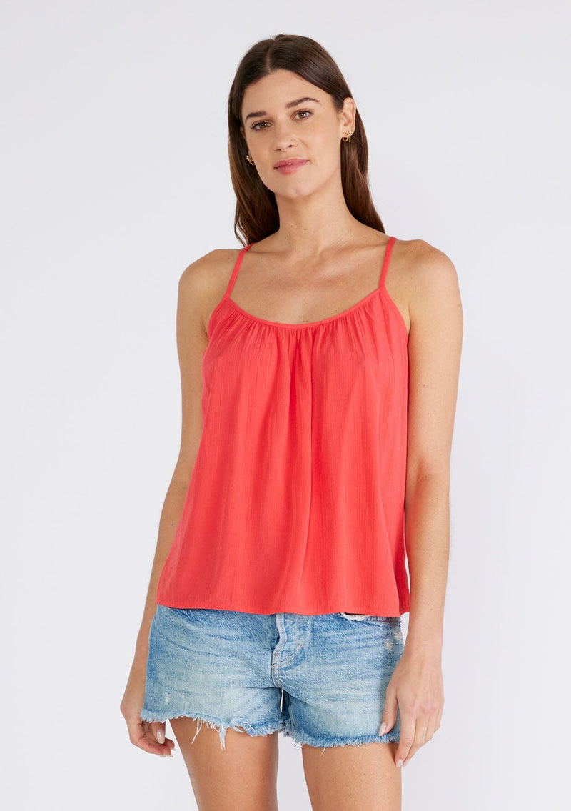 [Color: Hibiscus] A front facing image of a brunette model wearing a red bohemian tank top with a scooped neckline, spaghetti straps, and a sheer lace racerback detail. 