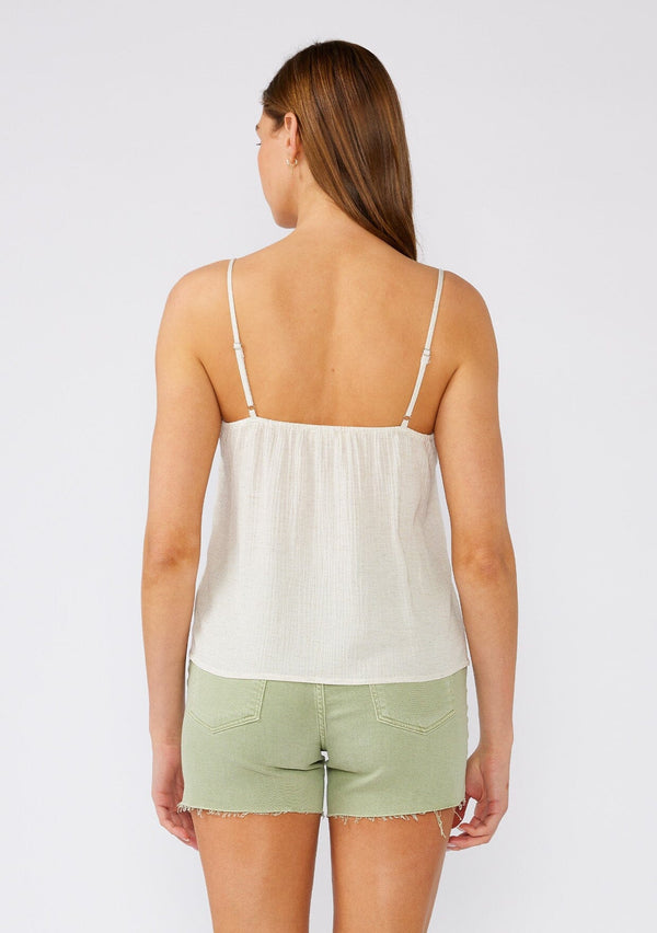 [Color: Natural] A back facing image of a brunette model wearing a classic off white bohemian camisole with lace detail along the neckline. With adjustable spaghetti straps and a scooped neckline. 