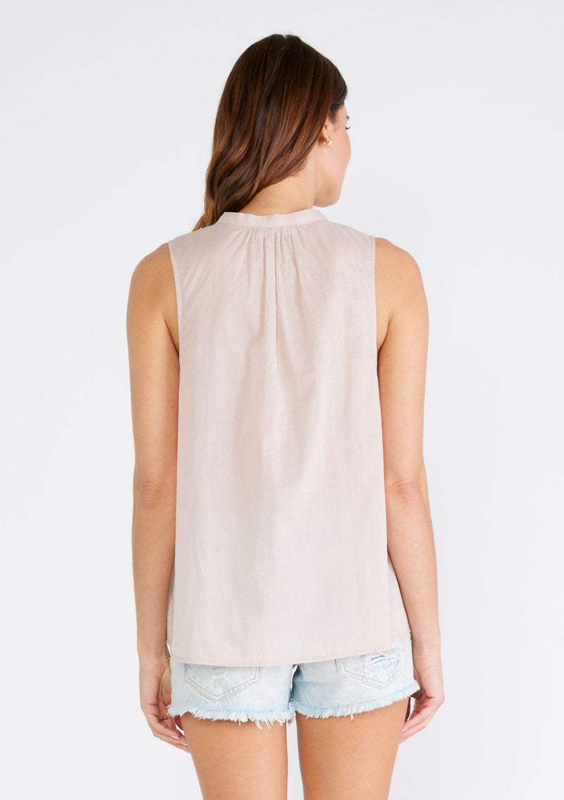 [Color: Mauve] A back facing image of a brunette model wearing a bohemian cotton tank top in a light mauve purple. With a v neckline, a loose, tent silhouette, and pleated details along the front.
