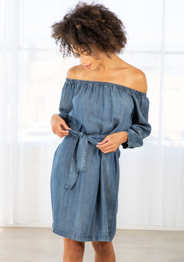 [Color: Dk Vintage Wash] An off shoulder mini dress crafted from blue tencel fabric. 