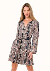 [Color: Dusty Rose/Navy] A front facing image of a blonde model wearing a bohemian fall mini dress in a blue and pink mixed floral print. With long sleeves, a split v neckline, a flowy paneled skirt, a button front, and an adjustable waist tie. 