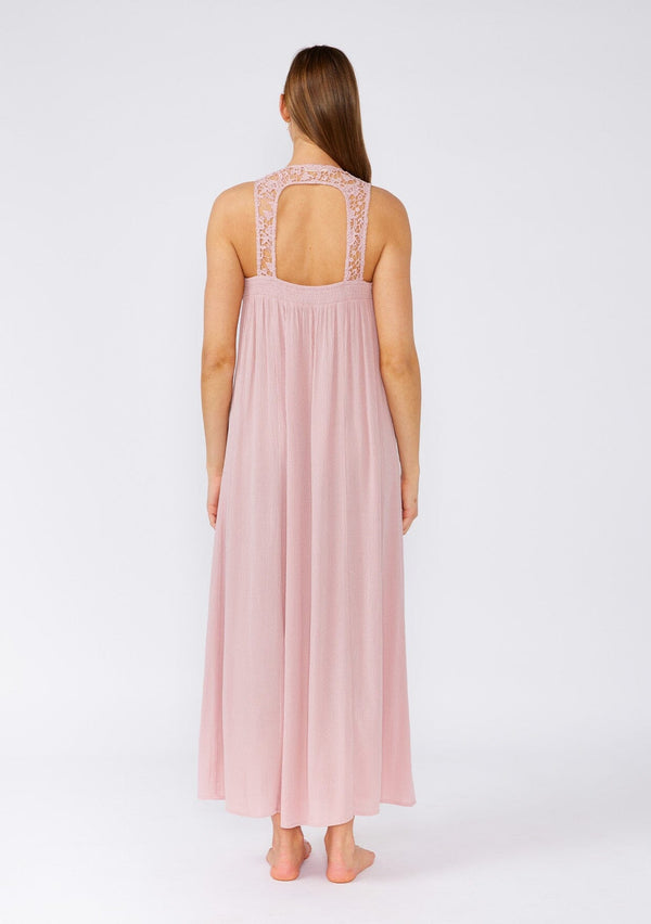 [Color: Dusty Rose] A back facing image of a brunette model wearing a flowy sleeveless bohemian maxi dress in dusty pink. With a crochet top, a scooped neckline, and an open back detail. 