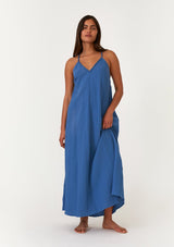 [Color: Ocean] A front facing image of a brunette model wearing a blue bohemian sleeveless maxi dress crafted from cotton gauze. With braided straps, a v neckline, a relaxed, flowy body, and a sheer crochet mesh racerback detail. 