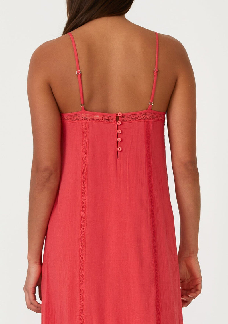 [Color: Hibiscus] A close up back facing image of a bright red bohemian sleeveless maxi dress. With adjustable spaghetti straps, a v neckline, a flowy tiered skirt with a high low hemline, a loop button up back detail, and lace trim. 
