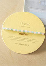 Bracelet with a mama charm with pink and green beads.