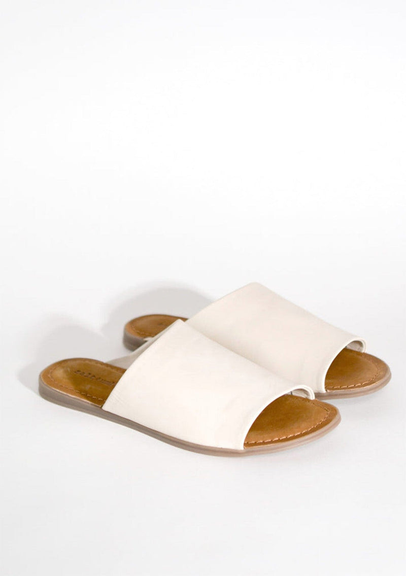 [Color: Bone] A timeless white leather slide sandal, ethically and sustainably made in India. 