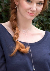 Sterling silver lariat necklace with a freshwater pearl and circle pendant. An elegant y necklace for v-necklines.