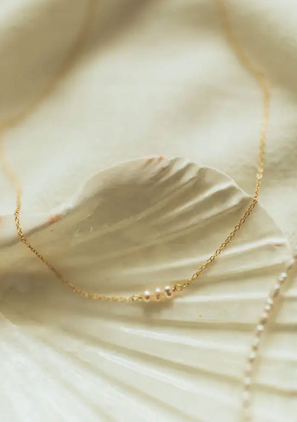 [Color: Gold] A delicate fourteen karat gold plated on sterling silver necklace with dainty freshwater pearls. Hypoallergenic and made in the USA.  