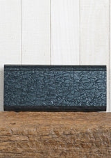 [Color: Black Pearl] A pearlescent clutch made from molded resin. Features a magnetic closure.