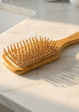Wooden hairbrush on a marble surface