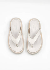 [Color: Creme] A minimalist pair of ivory thong platform leather sandals. 