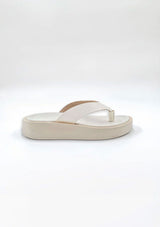 [Color: Creme] A minimalist pair of ivory thong platform leather sandals. 