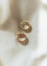 Cute hypoallergenic flower print hoop earrings, made with fourteen karat gold plated sterling silver base. Made in the USA.