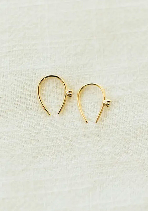 [Color: Gold] A chic, hypoallergenic earring with a horseshoe shape and a cubic zirconia stone. Featuring fourteen karat gold plating on top of one hundred percent sterling silver. 