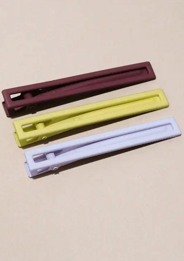 [Color: Desert Sky] A set of three long alligator style metal hair clips in lime green, light lavender, and brick brown.