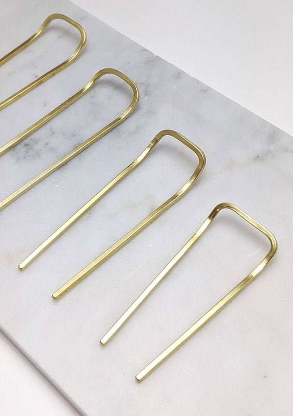 [Color: Brass] A simple hairpin handcrafted in the USA from recycled brass. 
