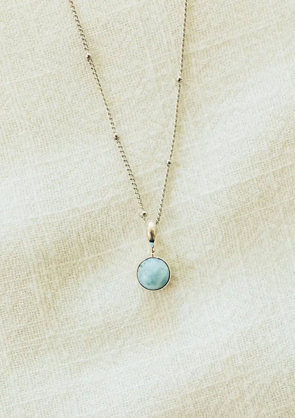 A white gold plated on sterling silver necklace with a unique larimar stone charm. Hypoallergenic and made in the USA!