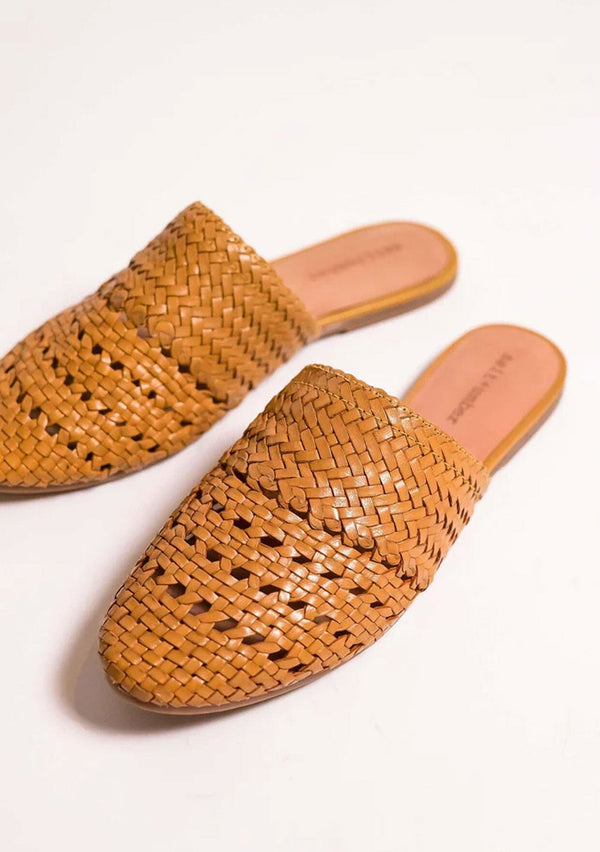 [Color: Mustard] Handwoven leather woven slip on mules in mustard yellow. With a flat rubber sole. Sustainably and ethically made in India.