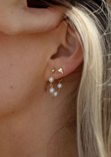 Delicate chain hoop earrings with freshwater pearls. Crafted from fourteen karat gold on sterling silver base, these beachy earrings are hypoallergenic and tarnish resistant.