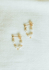 Delicate chain hoop earrings with freshwater pearls. Crafted from fourteen karat gold on sterling silver base, these beachy earrings are hypoallergenic and tarnish resistant.