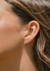 Delicate opal stud earrings. Hypoallergenic studs made with fourteen karat gold plated on a sterling silver base.