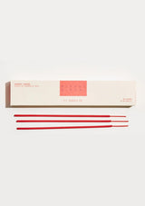 Incense sticks with a white box on a light gray background