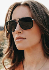 [Color: Matte Black] Black sunglasses with a modern, boxy silhouette.