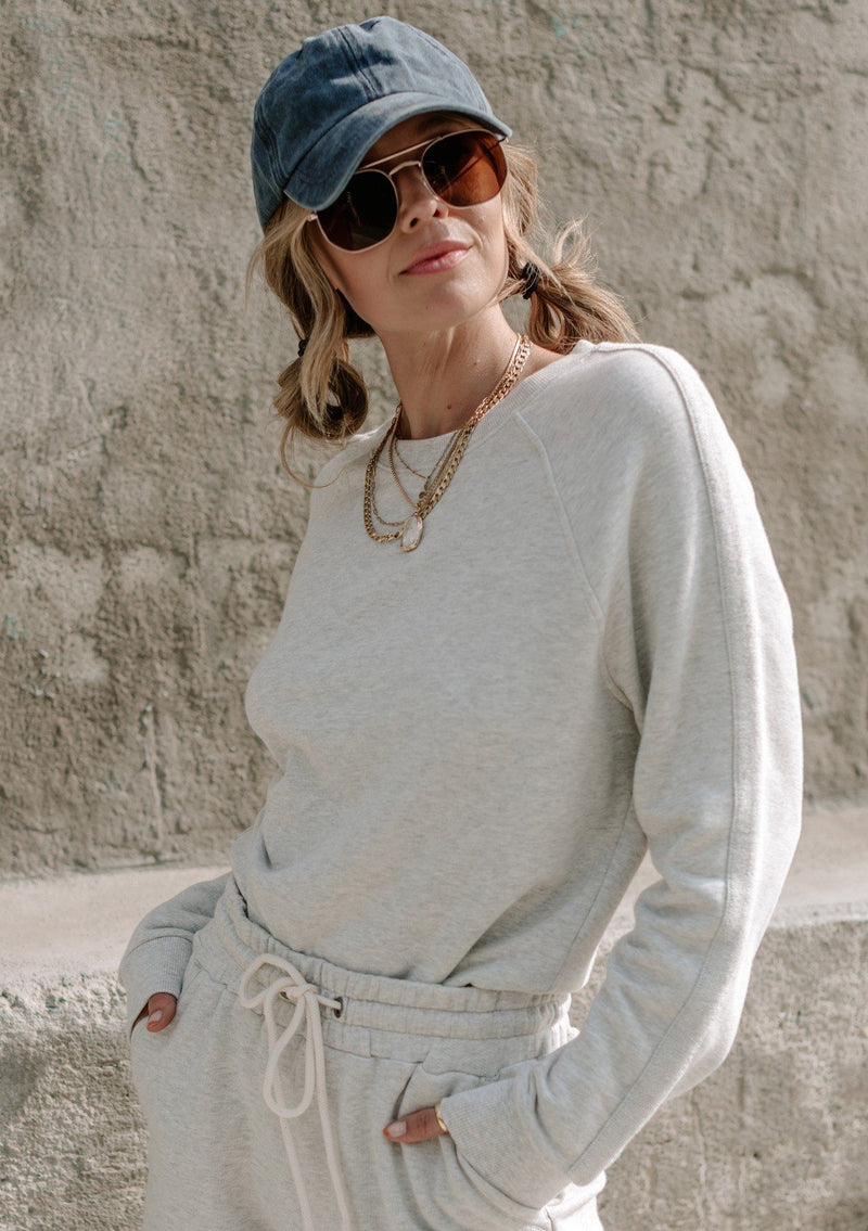 [Color: Heather Grey] A super soft hand feel elevates this essential sweatshirt to a whole new level of comfort. Featuring long raglan sleeves with a contrast trim, a relaxed easy fit, and a classic crew neckline. Whether you pair it with the matching drawstring shorts or jeans, this pullover will add a cool touch to your outfit. 