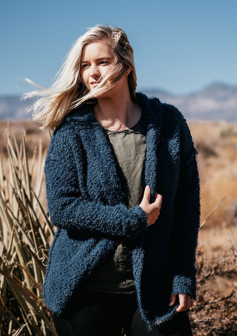 [Color: Dark Denim] A slouchy fuzzy hoodie cardigan. Featuring a cozy oversize hood, a relaxed open front, and a unique reverse seam detail. A buttery soft texture adds a luxe quality to this versatile sweater.