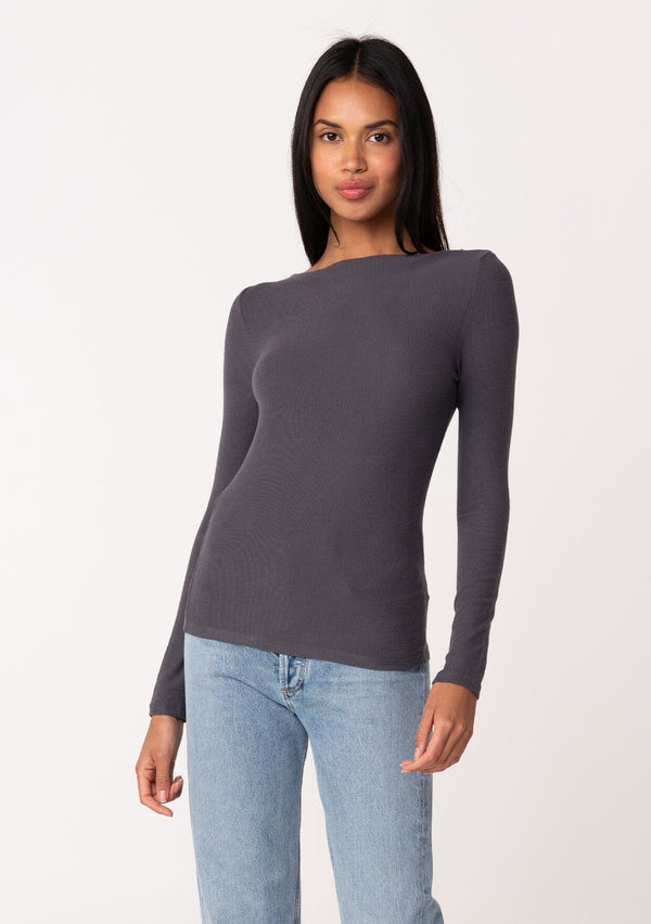 [Color: Charcoal] A front facing image of a brunette model wearing a charcoal grey bamboo micro ribbed long sleeve tee. Featuring a mock neckline and a stretchy slim fit.