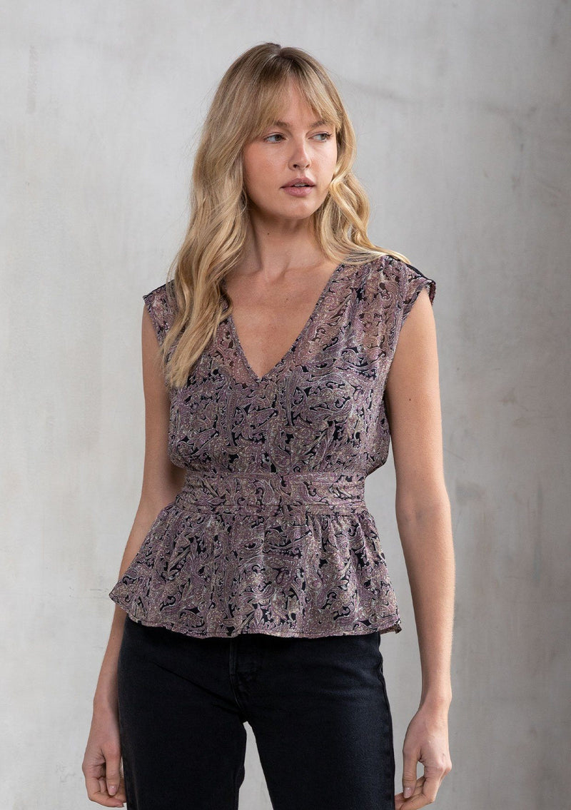 [Color: Black/Orchid] A model wearing an ethereal sheer chiffon sleeveless top in an autumnal black and purple paisley print. With a crochet shoulder detail and a flattering peplum waist. 