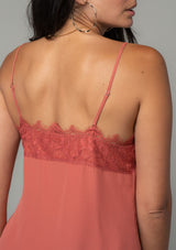 [Color: Rosewood] A close up back facing image of a brunette model wearing a dusty rose pink lace trim camisole with a v neckline, adjustable spaghetti straps, and a flowy relaxed fit. 