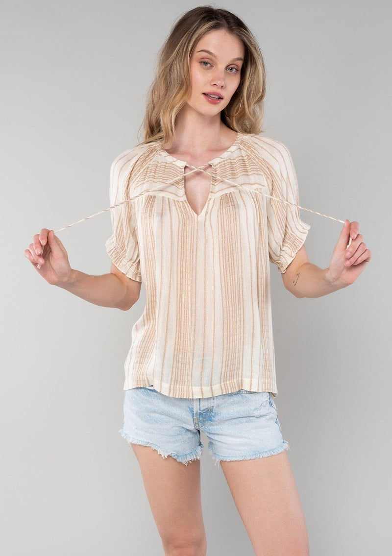 [Color: Natural/Tan] A half body front facing image of a blonde model wearing a bohemian spring top in a natural and tan stripe. With short puff sleeves, a split v neckline with ties, and a flowy relaxed fit. 