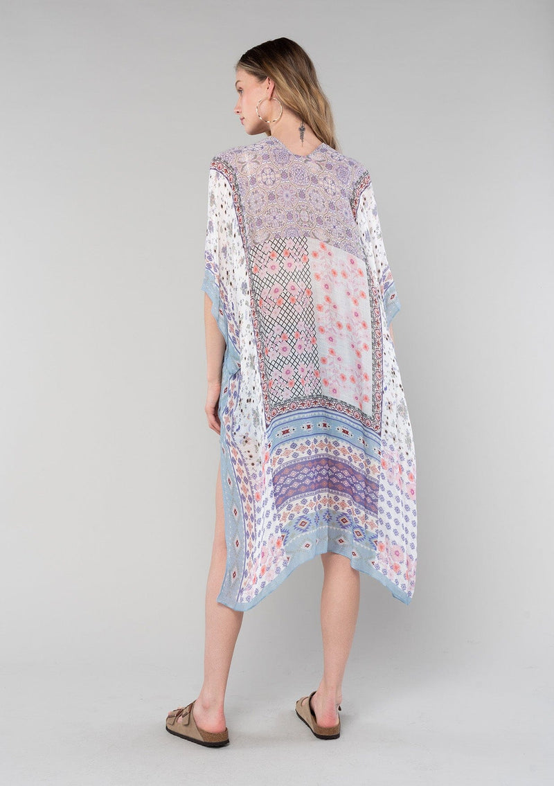 [Color: Ivory/Light Rose] A back facing image of a blonde model wearing a lightweight bohemian mid length kimono in an ivory and light pink mixed floral border print. With half length kimono sleeves, an open front, and side slits. 