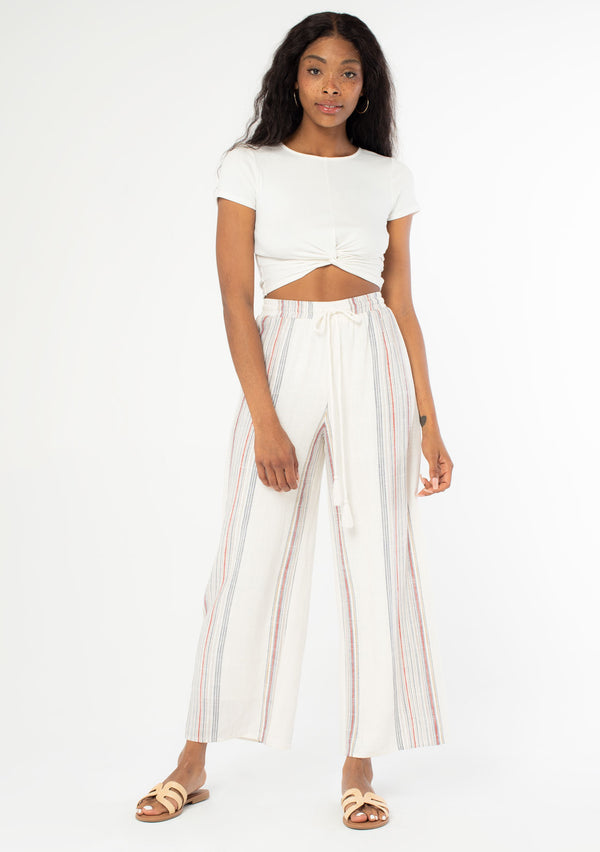 [Color: Ivory/Red] A full body front facing image of a black model wearing an off white and red striped wide leg drawstring pant. 