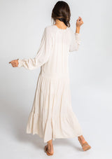 [Color: Vanilla Bean] A model wearing a versatile off white bohemian maxi dress. Features a classic peasant dress silhouette, a relaxed fit, and delicate textured dot details throughout.
