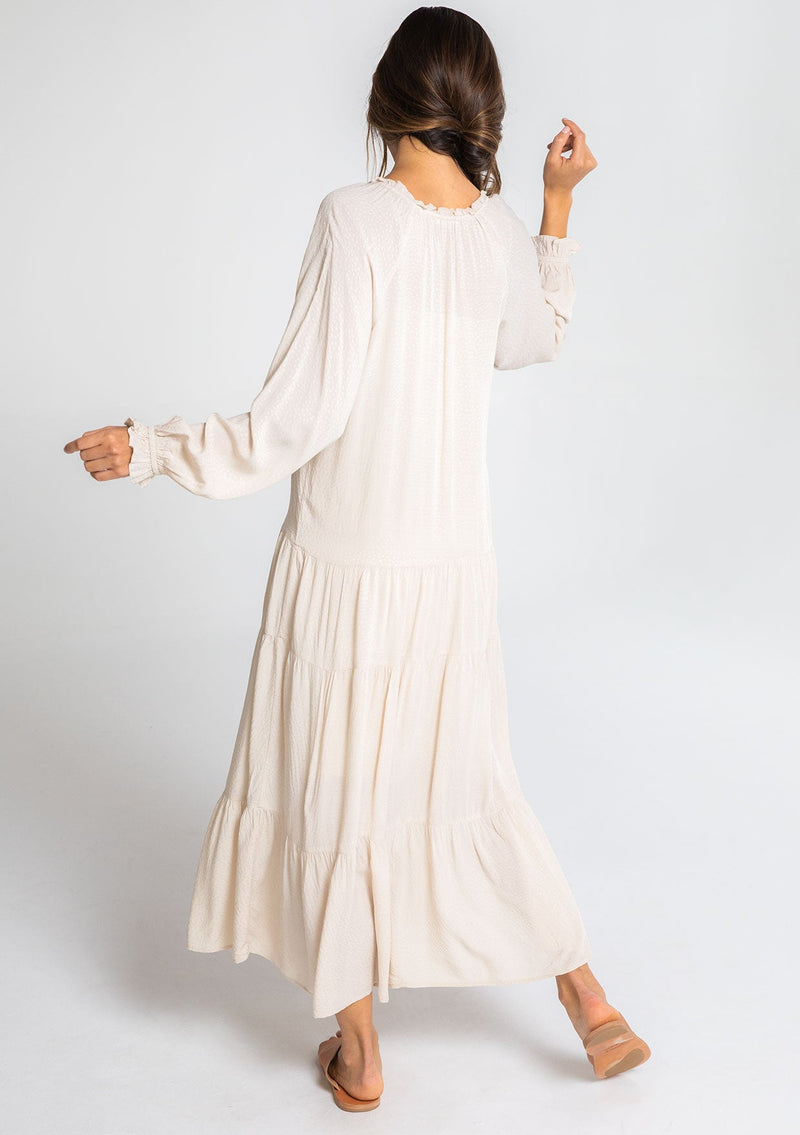 [Color: Vanilla Bean] A model wearing a versatile off white bohemian maxi dress. Features a classic peasant dress silhouette, a relaxed fit, and delicate textured dot details throughout.