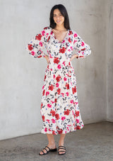 [Color: Cream/Red] A model wearing a bohemian white maxi dress in a red floral print. 