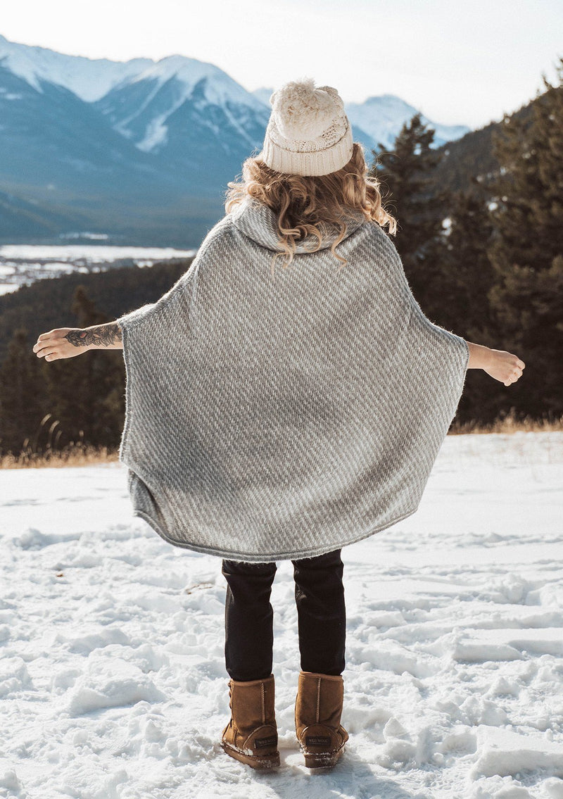 [Color: Ivory/Silver] An irresistibly warm and soft wool blend sweater poncho. Featuring a relaxed, oversized silhouette and a cozy cowlneck. 