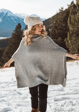 [Color: Ivory/Silver] An irresistibly warm and soft wool blend sweater poncho. Featuring a relaxed, oversized silhouette and a cozy cowlneck. 