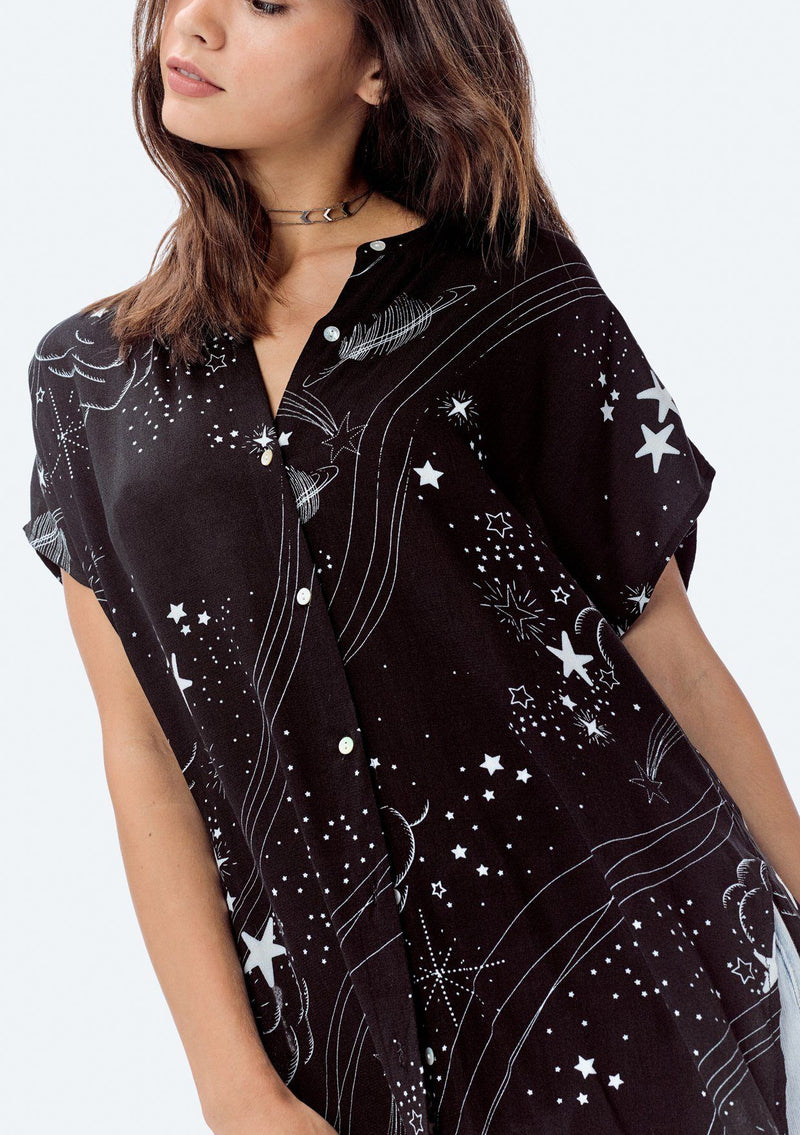 [Color: Black] Flattering knee length button front black tunic top with white stars, space dust and Saturn print.  Super versatile and casual top that can be tied up in the front and left long in the back for a unique and flattering style.