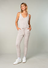 [Color: Heather Oatmeal] Girl wearing a cozy knit sleeveless lounge jumpsuit.