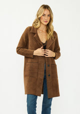 [Color: Brown/Black] A front facing image of a blonde model wearing a brown plaid sweater coat with a notched collar, button front, and front patch pockets. 
