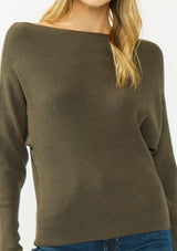 [Color: Olive] A detail image of a blonde model wearing an olive pullover sweater with a boat neckline and long sleeves that taper at the cuffs. 