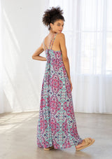 [Color: Coral/Mint] A back facing image of a brunette model wearing a pink and blue bohemian printed maxi dress with spaghetti straps, a v neckline, and an empire waist. 