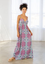 [Color: Coral/Mint] A front facing image of a brunette model wearing a pink and blue bohemian printed maxi dress with spaghetti straps, a v neckline, and an empire waist. 