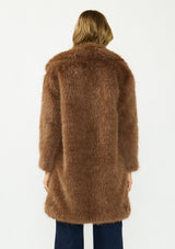 [Color: Mocha] A back facing image of a blonde model wearing a brown faux fur coat with a shawl collared neckline, and side pockets. A large fur coat for the winter, holidays, and other special occasions. 